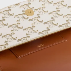 CLUTCH ON STRAP TABOU in Triomphe canvas and calfskin