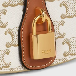 CLUTCH ON STRAP TABOU in Triomphe canvas and calfskin